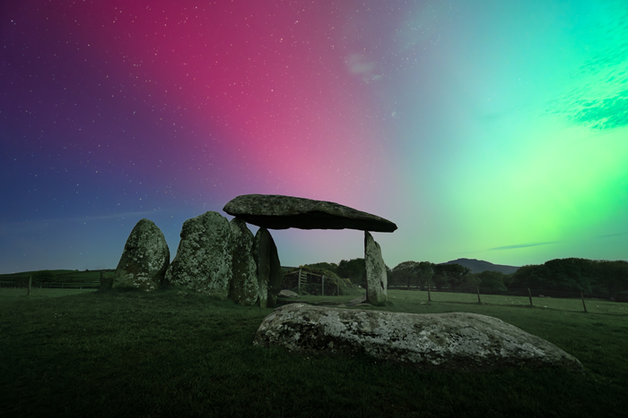 Under the northern light, a stone monument is sitting.
