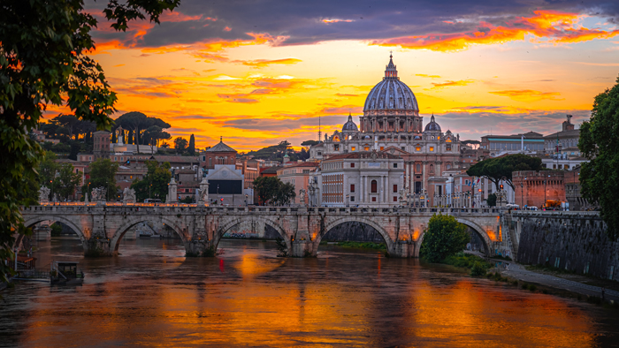 A clear picture of the Rome along the river in the preview and the dome of St. Peters Basilica beyond.