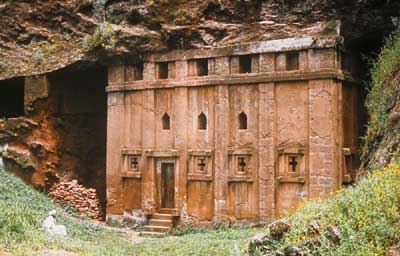 Priest in Bet Danaghel Church holding the Cross of King Lalibela. The  rock-hewn churches of Lalibela make it one of the greatest  Religio-Historical sites not only in Africa but in the Christian